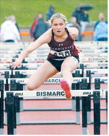 Meggy Hetletved races to a seventh-place finish in the 100-meter hurdles at the NDHSAA Class B State Track and Field Meet. Photo by Larry Stokke