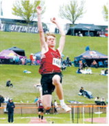 Caleb McDonald soars 20 feet, 8¼ inches in the long jump to earn fifth place at the NDHSAA Class B State Track and Field Meet. Photo by Larry Stokke