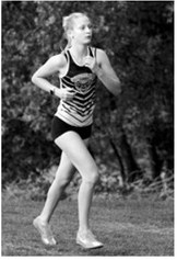 Pembina County North’s Maci Puppe races to a seventh-place finish among 60 runners during the cross-country meet Tuesday, Aug. 25, in Northwood. Photo by Larry Stokke