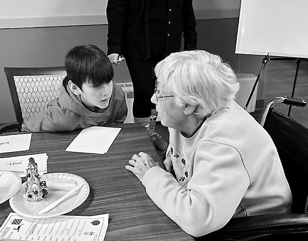 Eileen and Caleb chit-chat after working on their edible trees.