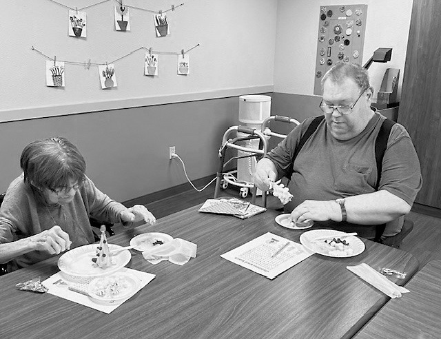 Rose and Richard working hard on their edible trees.