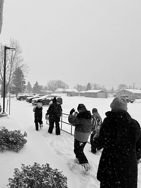 The sixth graders briskly walking back to their ride.