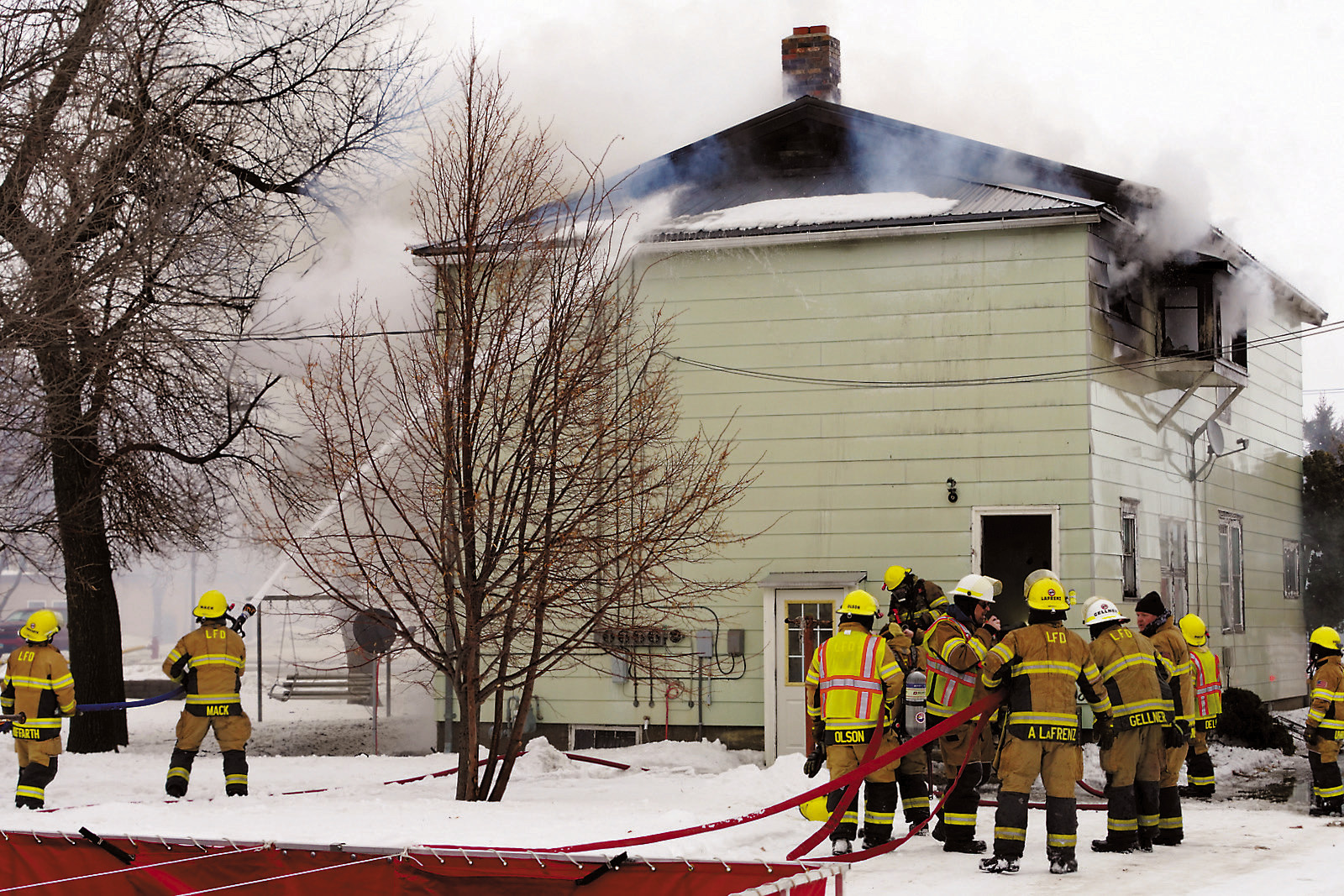Fire crew members attempt to put out Sunday's blaze on 3rd Street which broke out around 4:30 p.m. Photo by Larry Stokke.