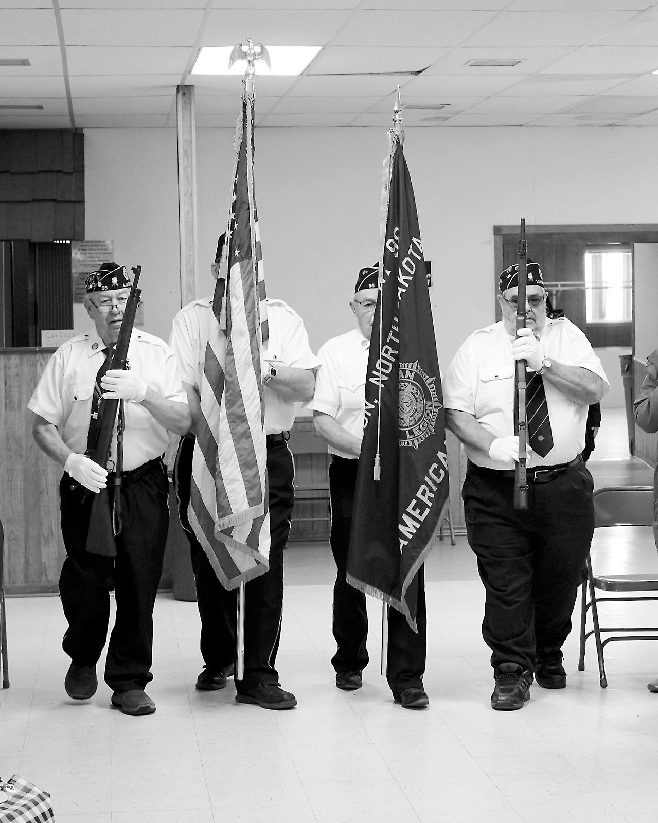 Post 98 Color Guard advance the colors to start the program. Photo by Larry Stokke.