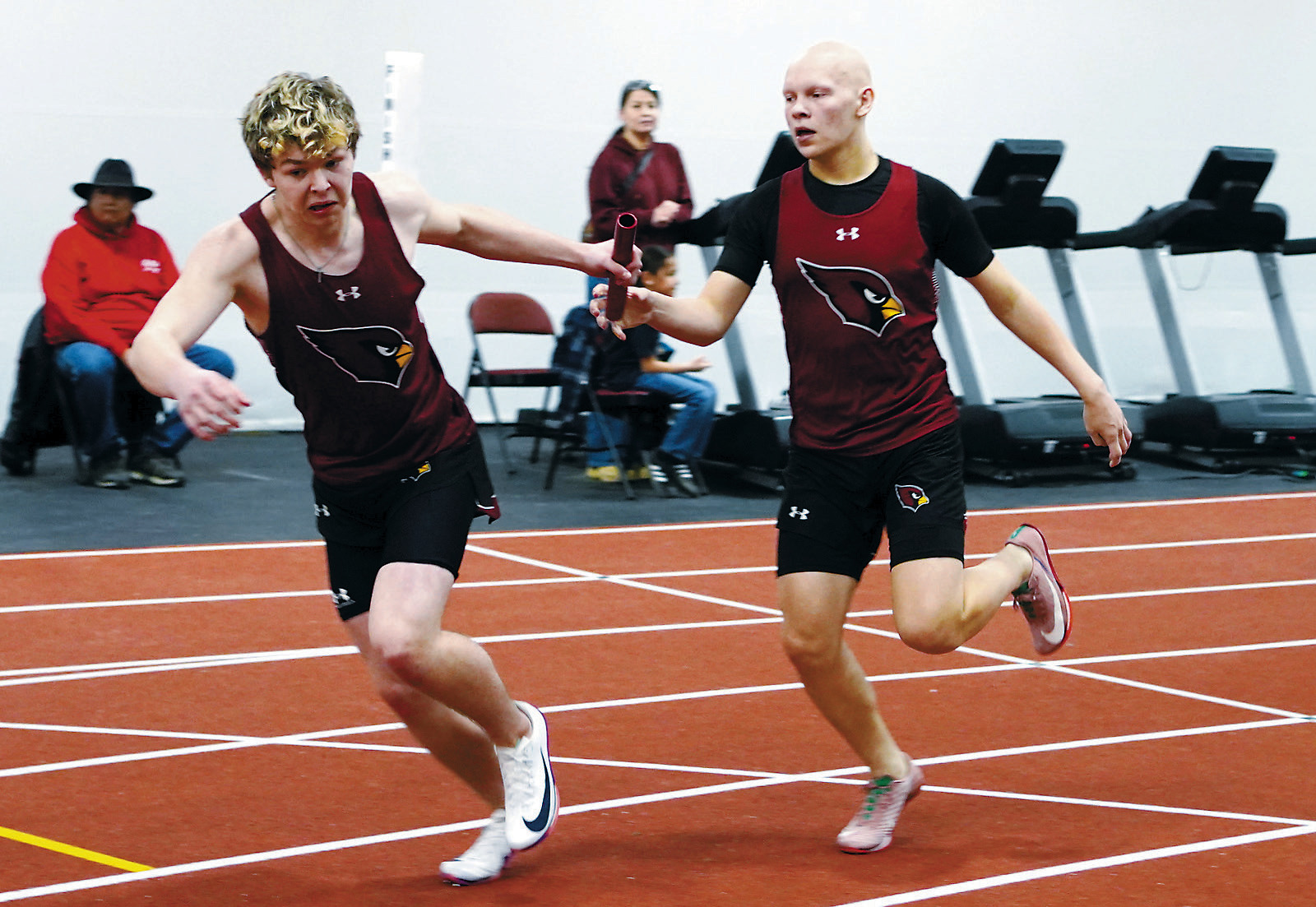 In the 4X200-meter relay, Gavin Trottier hands off to Braxton Lindseth, who was also named Performer of the Meet for the Cards. Other relay members were Evan Ottem and Brett Bryant. The relay team took fourth place. Photo by Larry Stokke