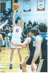 Maddux Stremick fires off a shot from the top of the key in the game against the Eagles in the first round of the Region 2B Tourney. Photo by Larry Stokke