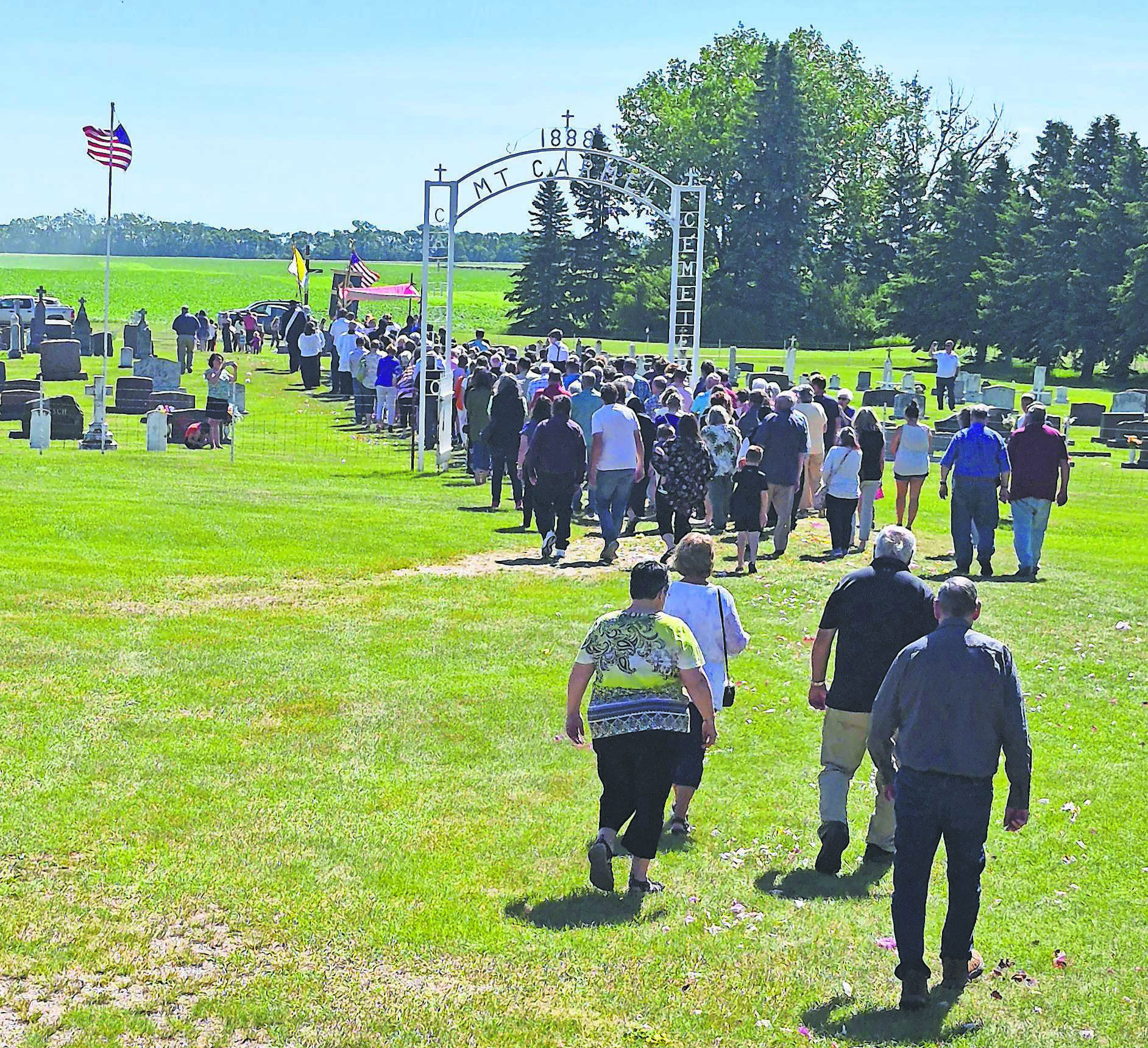 A procession through the cemetery followed the final mass held last Sunday. Reverend Schill discussed how the Our Lady Mt. Carmel Cemetery Fund is currently at $40,000, but needs to be closer to $100,000 to be a viable, lasting foundation. PHOTO BY HILARY NOWATZKI.