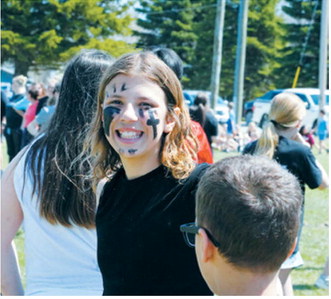 Brooklyn Mondor sports game-day face paint as she prepares to take the field during the annual sixth grade vs. teachers kickball game, one of several end-of-the-year activities at Langdon Area Elementary. Photo by Larry Stokke