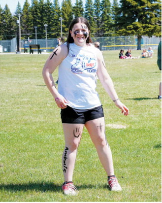 Lizzie Hakanson embraces the competitive spirit with face paint and enthusiasm before the annual students-versus-staff kickball showdown. Photo by Larry Stokke
