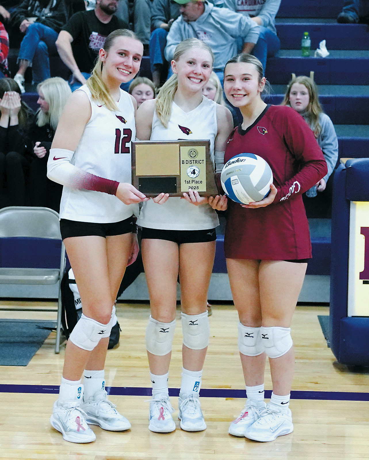 From (L-R) Kemi Morstad, Hilary Haaven, and Raeleigh Ratzlaff accept the 1st place plaque and game ball after taking first place in the District 4 Tournament in Rolla on Nov. 3. Photo by Larry Stokke.