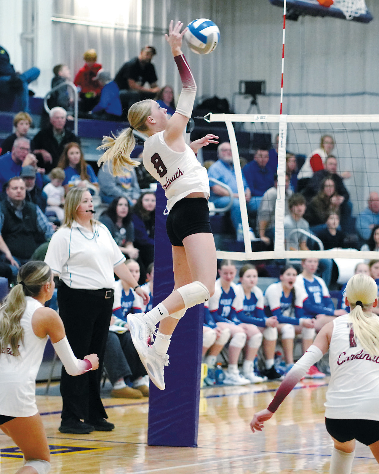 FM Bank's Player of the Game Hilary Haaven slams down one of her 19 kills, finishing the game with 16 digs, eight blocks and four aces. Photo by Larry Stokke.