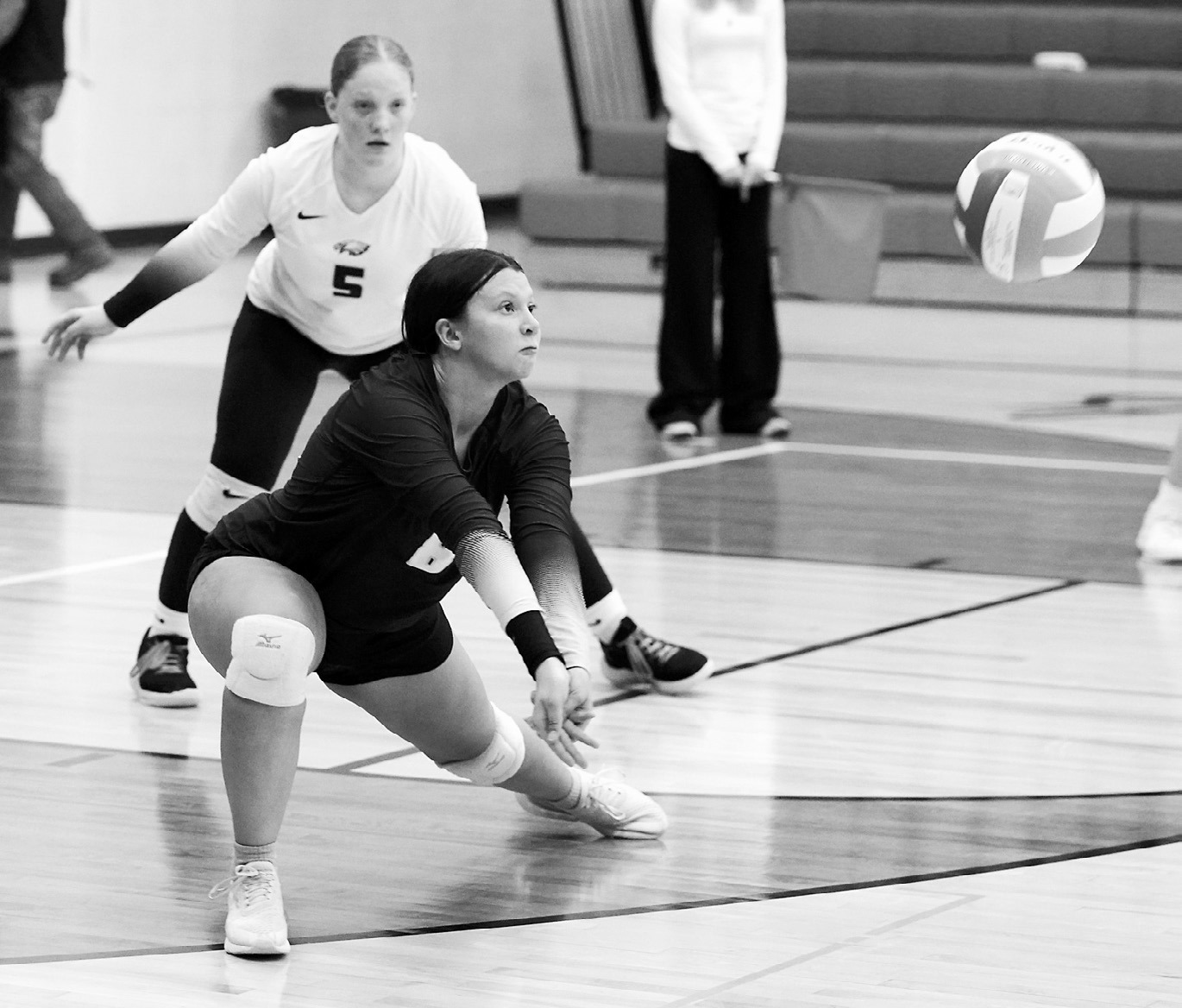 Jasmine Burch eyes the ball before hitting a dig in the game against the Cardinals. Photo by Larry Stokke.