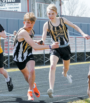 Nash Fitzimonds hands the baton to Owen Crosby. Along with teammates Mason Heller and Gunder Kemp, the 4X800 relay team took 2nd place. Photo by Larry Stokke.