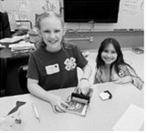 Sign Etching: Ava and Olive personalize their sign. Submitted photo