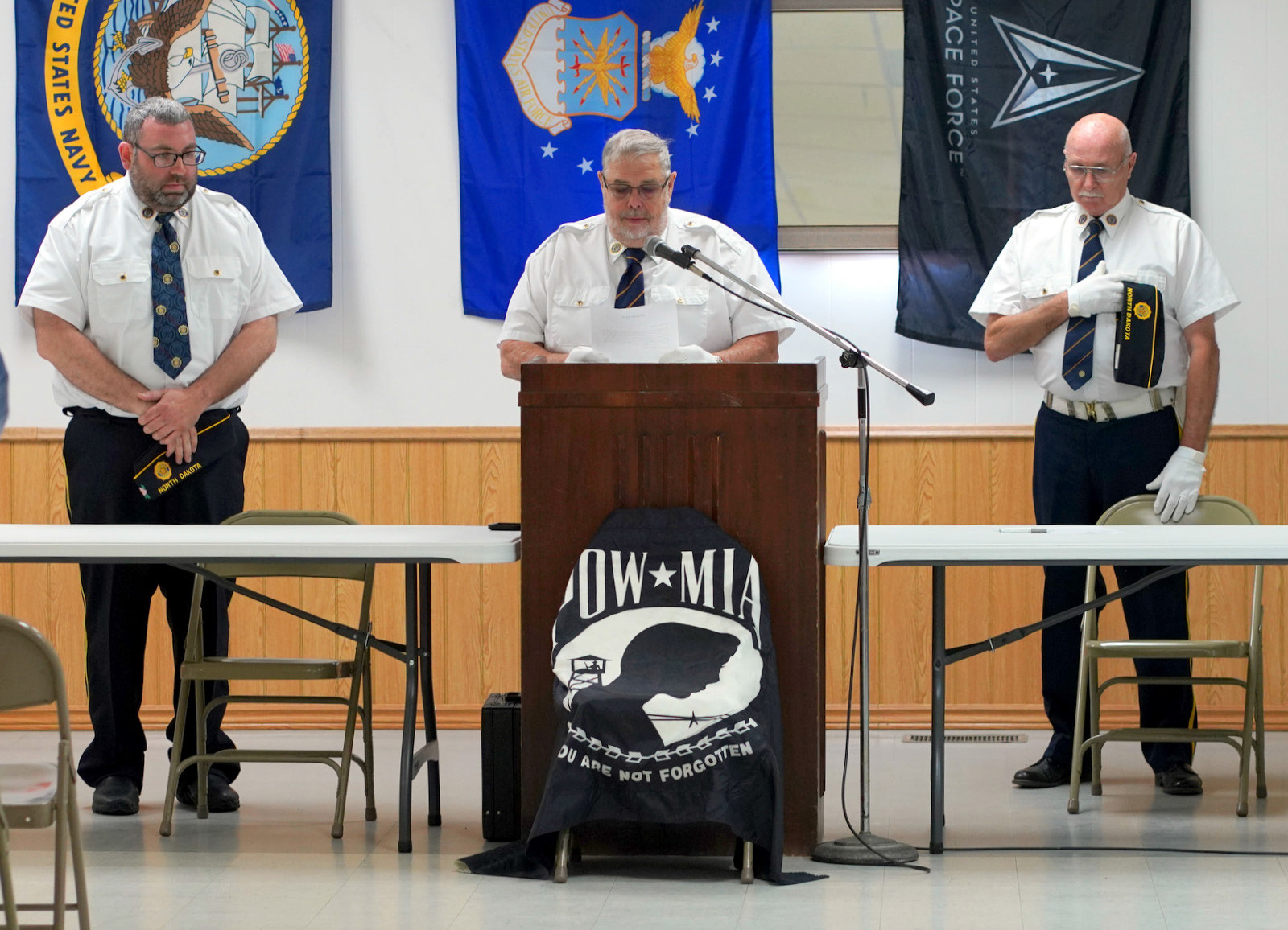 Chaplin Dennis Hansel 9center) closes the program with a benediction with Commander Anderson (left) and Leon Hiltner (right). Photo by Larry Stokke.