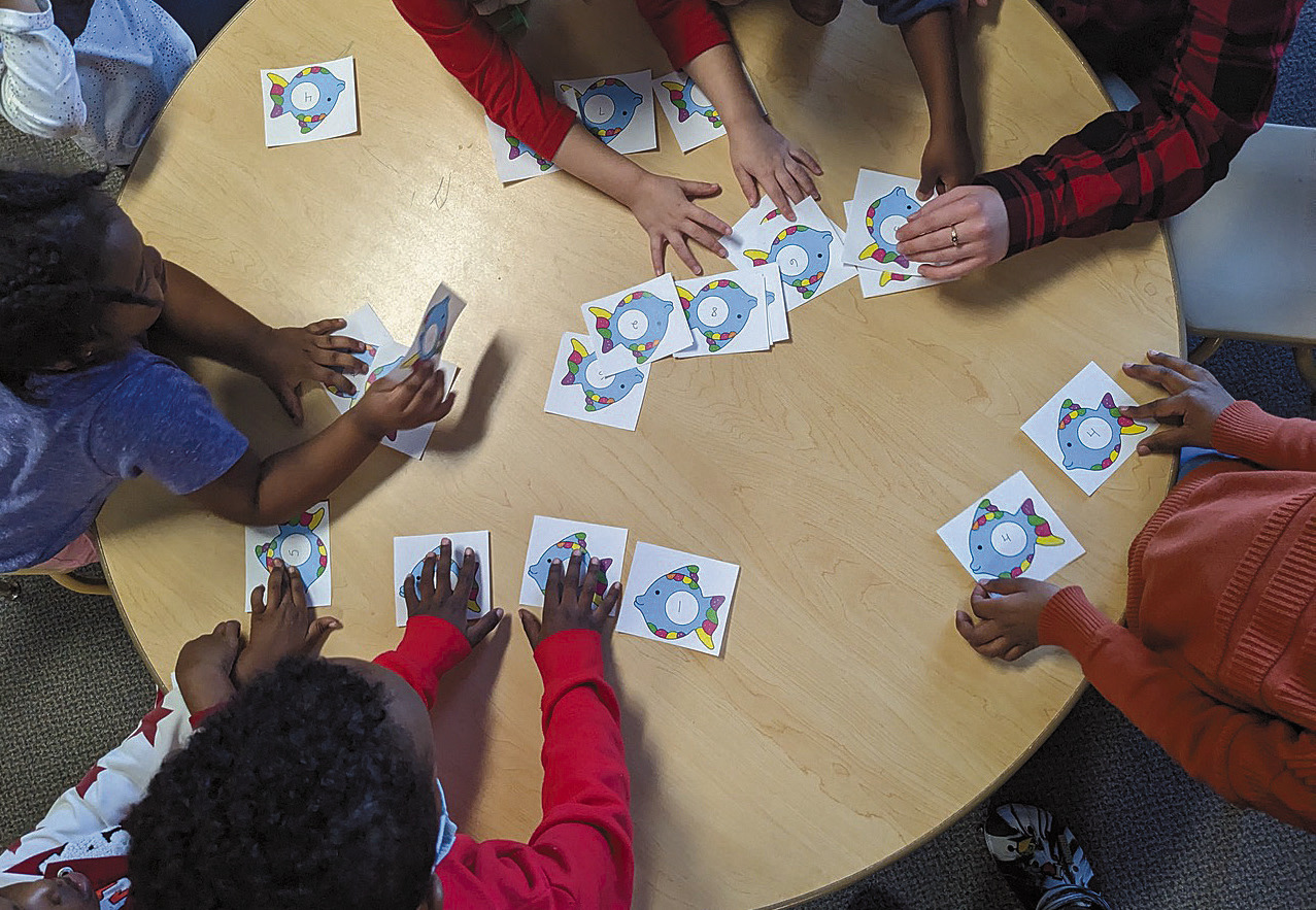 According to analysis of the most recent data by Kids Count North Dakota, child care capacity only meets 81 percent of the needs in the state with costs running close to $10,000 per year for infant day care. Here, children play a numbers game at Jasmin Child Care and Preschool in Fargo. Photo courtesy of Jasmin Child Care.