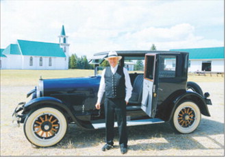 Curtis Olafson portrays G.B. Gunlogson while seated in an antique automobile at the Pembina County Historical Museum on Sunday, Aug. 16. Photo by Larry Stokke