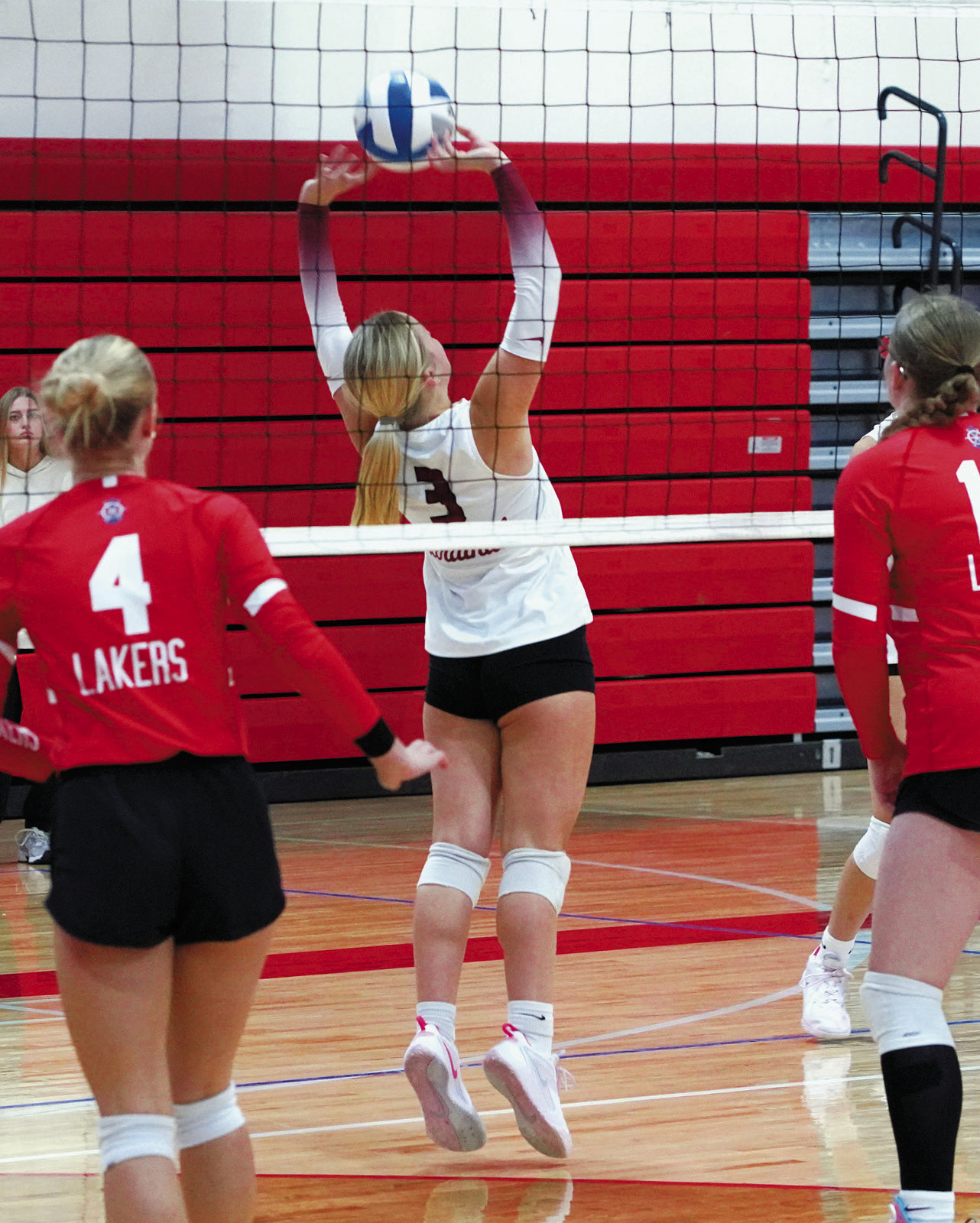 Payton Hall backsets the ball to a teammate who sends it over for a kill. Photo by Larry Stokke.