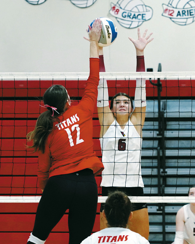 Taya Feist blocks a Titan player in the DLB Tournament. Photo by Larry Stokke.