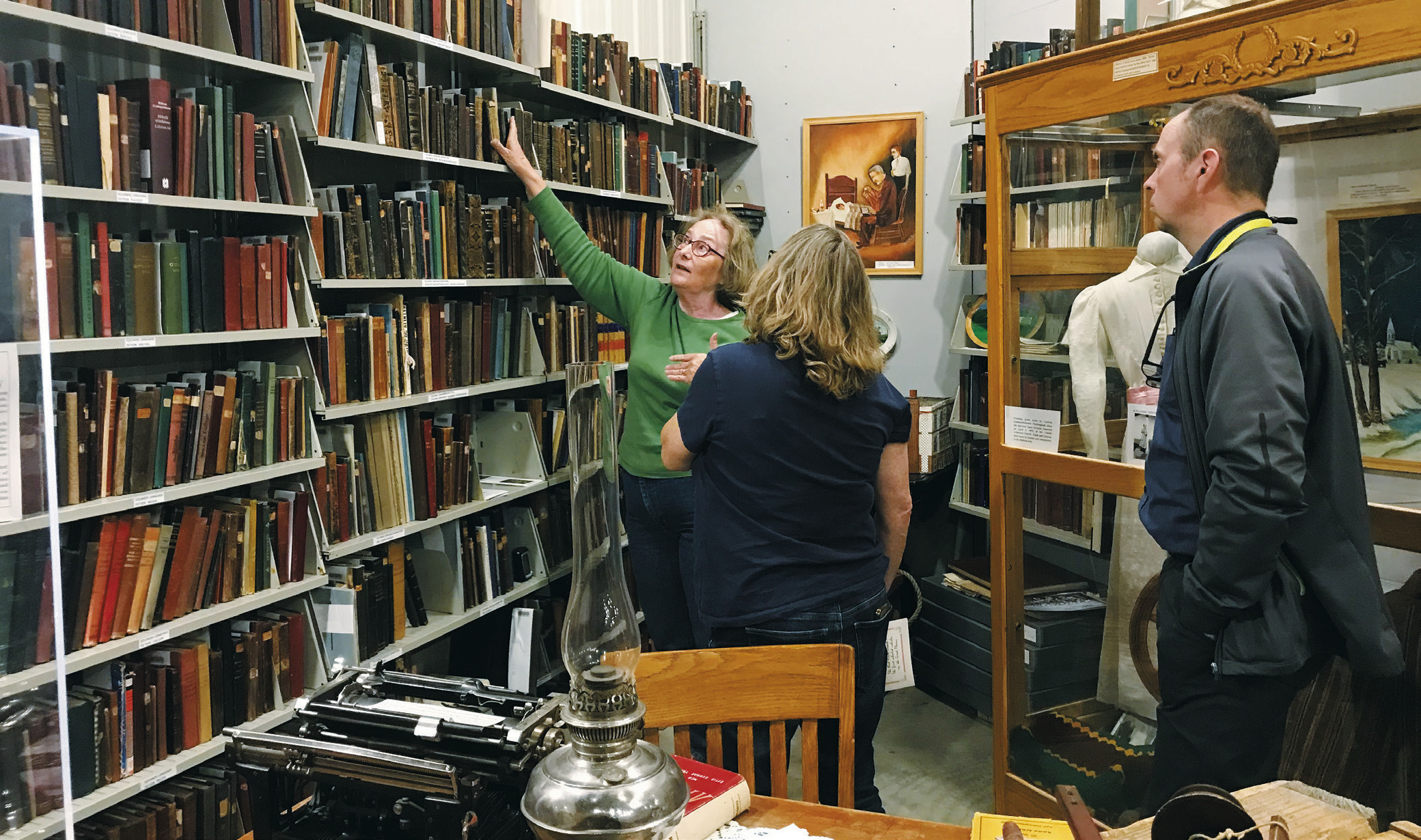 Kristín Jóhannsdottir and Hórður Gunnarson learning about the Icelandic book collection from museum director Zelda Hartje at Pembina County Historical Society Museum.