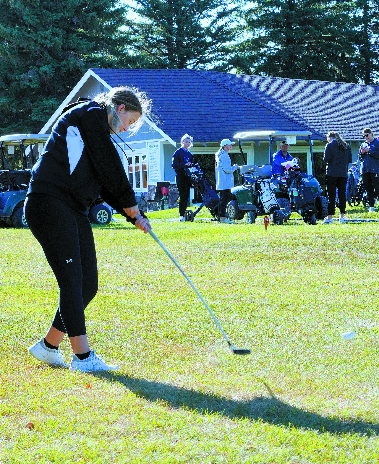 Nadia Lewis tees off at the first golf meet of the year in Park River. Photo by Larry Stokke.