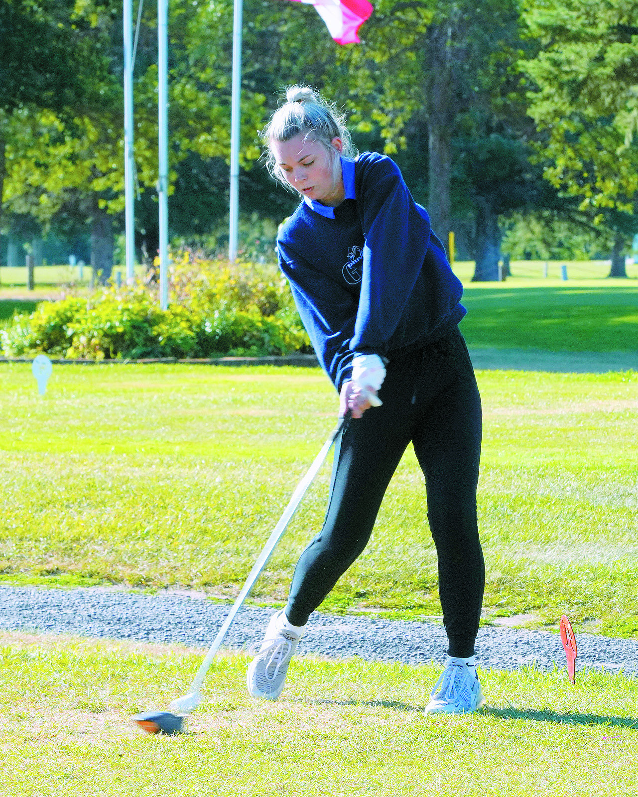 Rylee Medbery eyes the golf ball as she tees off on Aug. 9 at the first meet of the season. Photo by Larry Stokke.