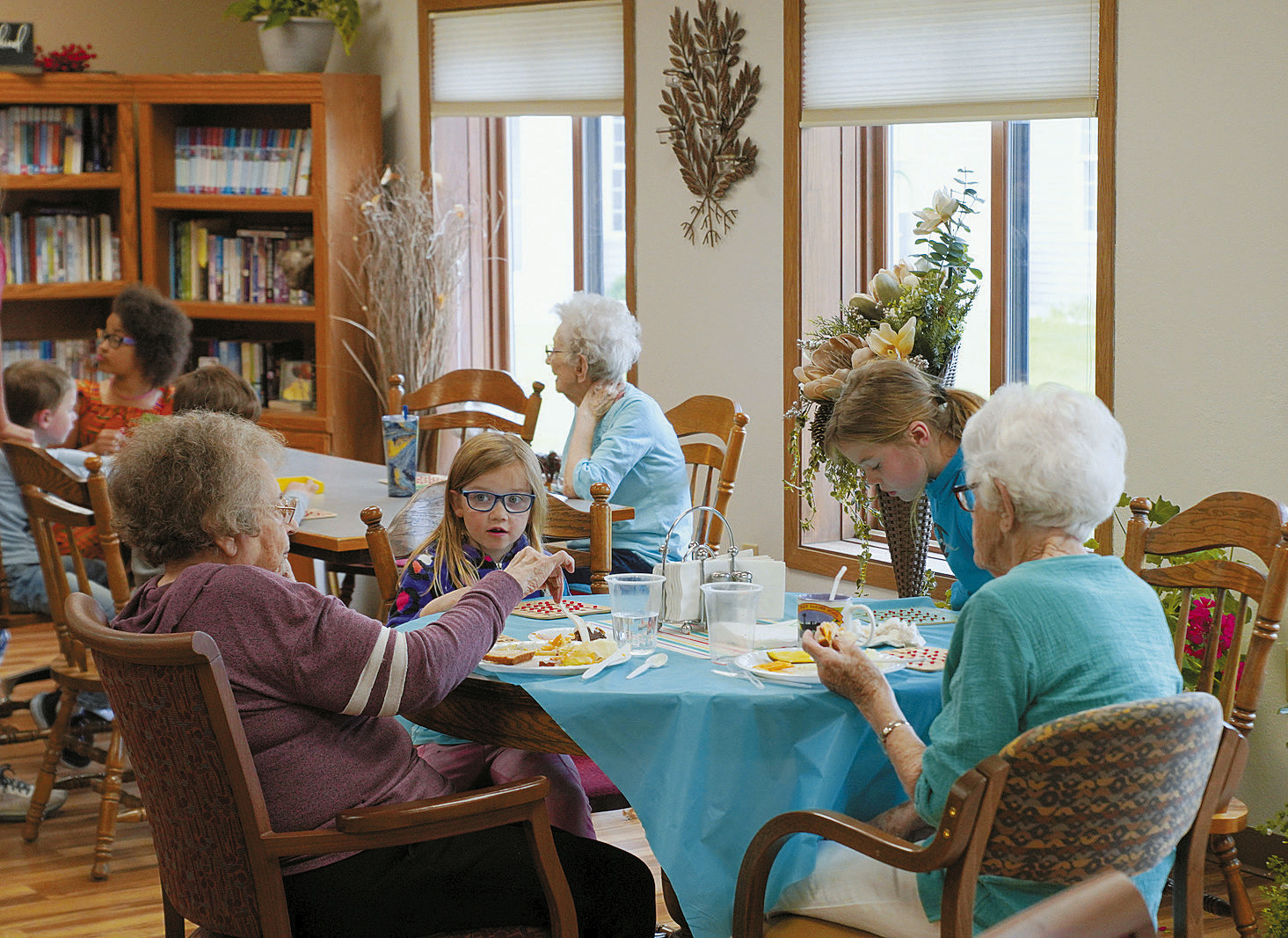On Wednesday of last week, a group of kindergarten through 3rd grade Munich students took a field trip up to Langdon. They had a few stops to make, one being at Wheatland Estates to spend time with residents. The students kept residents company while enjoying snacks, watching cartoons, and playing bingo! Photos by Larry Stokke.