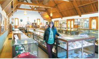 Author visit: Author Susan D. Levitt, whose book Secrets in the Woods was featured during a special signing, poses inside the Dresden Museum on June 21. Levitt visited with readers and signed copies of her book during the Cavalier County Historical Society's Father's Day Breakfast, which drew nearly 700 people. Photo by Larry Stokke