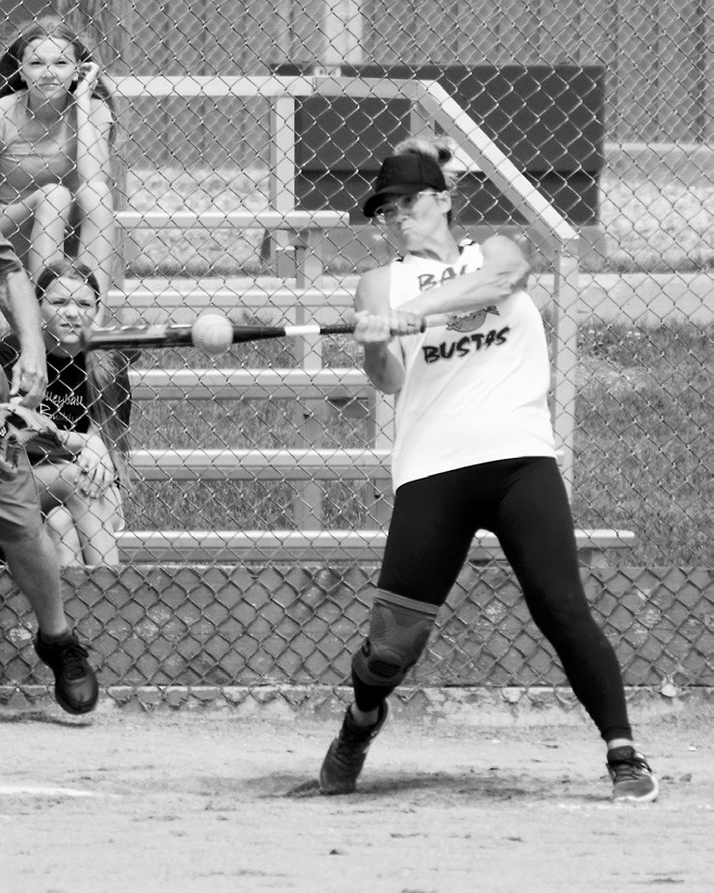Barb Crockett eyes the ball and sends it into the outfield. Photo by Larry Stokke.