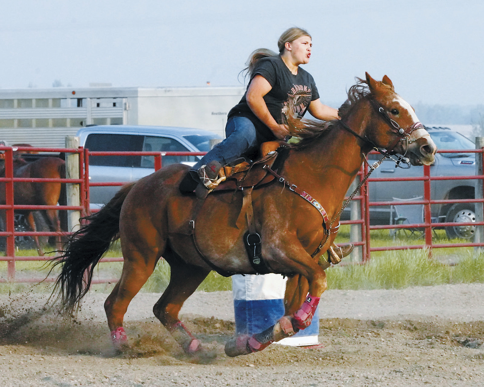 Madi Knoke on her horse Shooter rounds a barrel at the run in Devils Lake on June 10. Photo by Larry Stokke.