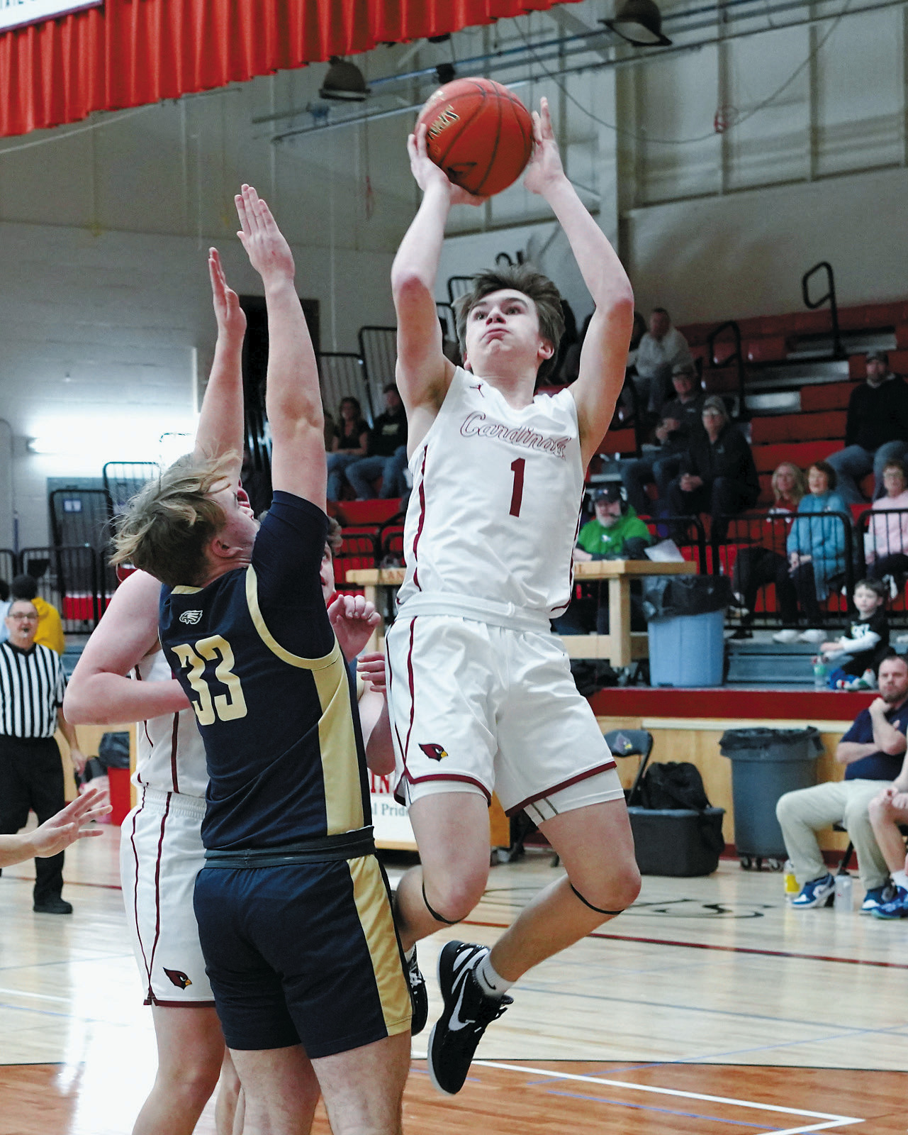 Eastyn Schaefer takes a leap and sinks a bucket at the Cards' faceoff against the Eagles. Photo by Larry Stokke.
