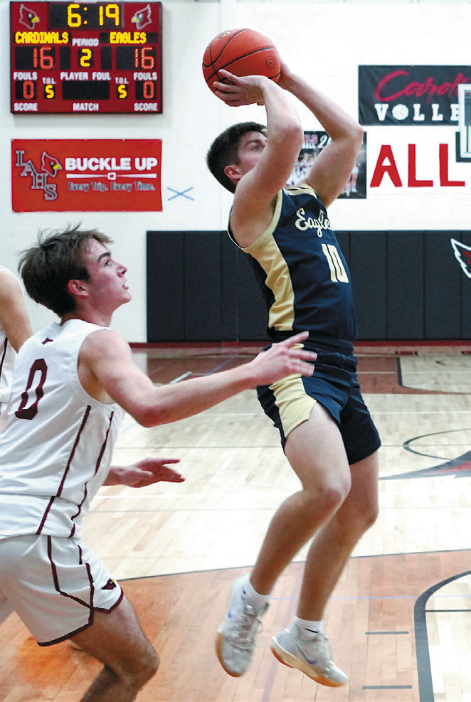 Colton Bailly eyes the basket and puts up a shot during the Eagles’ win over the Cards on Jan. 31 in Langdon. Photo by Larry Stokke.