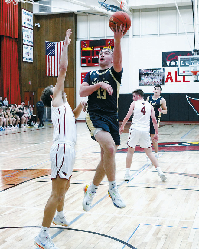 Kade Schafer sinks a left handed shot to add two more points to his game high of 23 points in the Eagles' win over the Cardinals on Jan. 31 in Langdon. Photo by Larry Stokke.