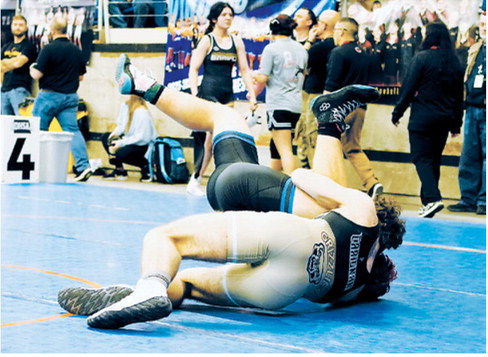 Bryce Carington takes his opponent to the mat and won his match by decision. Photo by Larry Stokke