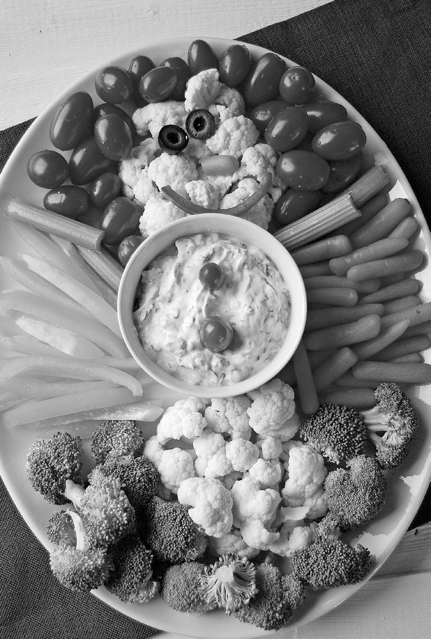 Bring a healthful dish to your next holiday party. How about a veggie tray shaped like a snowman with spinach dip? (photo by Pixabay)