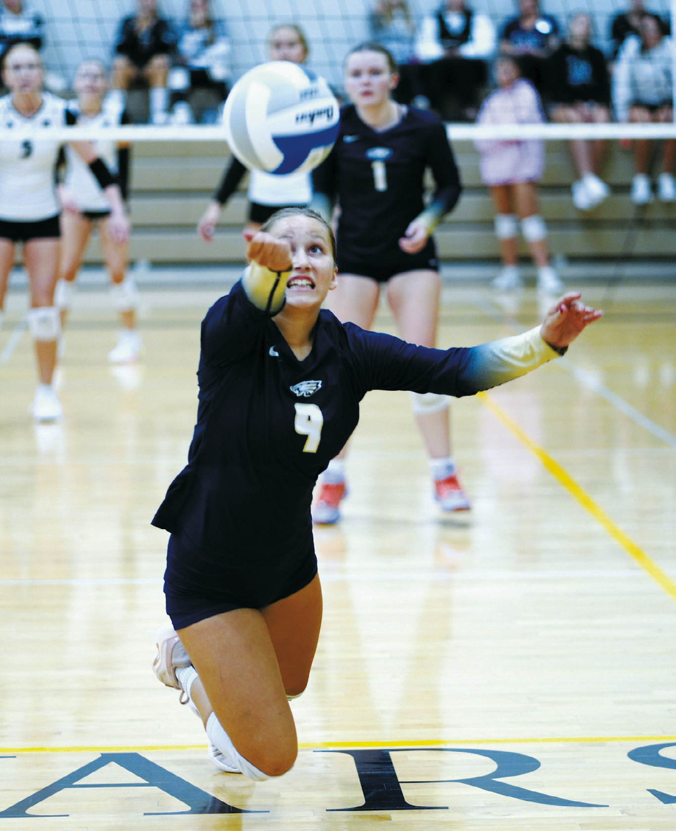 Adrienne Longtin drops to her knees to dig the ball for the North Border Eagles during the Northern Cass Tournament on Aug. 29. Photo by Larry Stokke