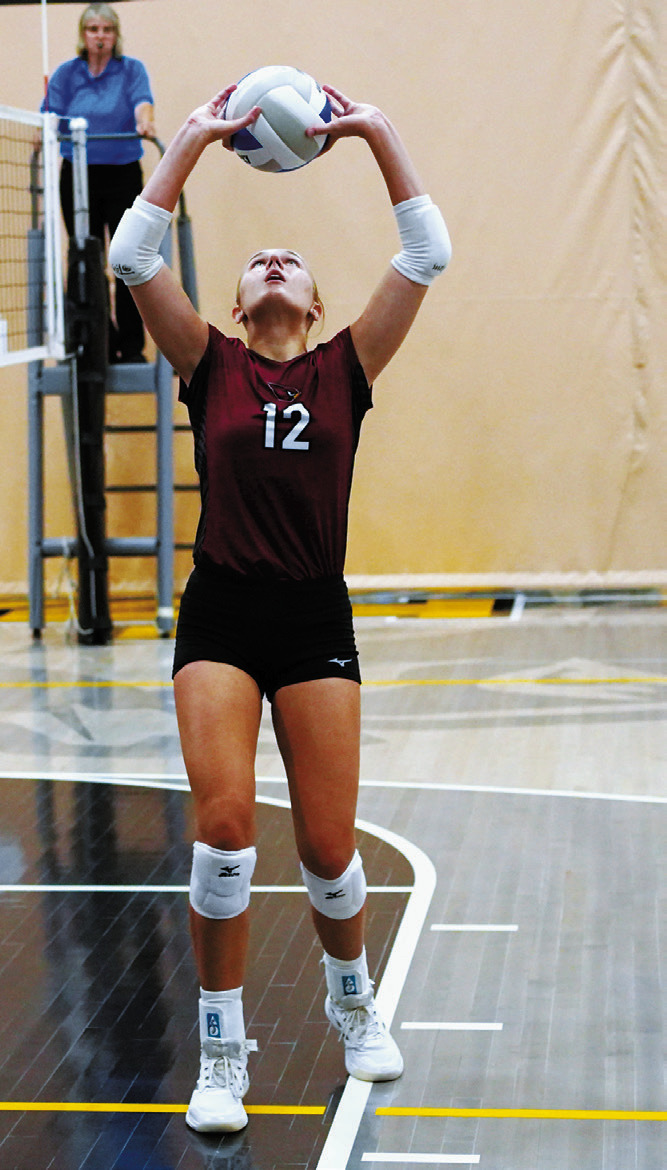 Kemi Morstad sets the ball for a Cardinal attack during the tournament Aug. 29. Photo by Larry Stokke