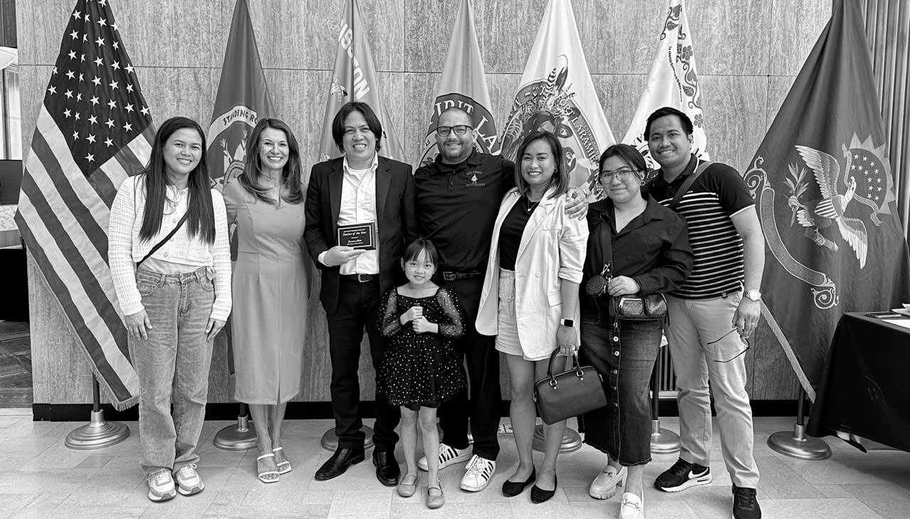 Eamon Alido, a teacher from the Philippines at the Mott-Regent Public School District, receiving an award from state school superintendent Kirsten Baesler (pink) for county teacher of the year in Hettinger County in 2024. Many teachers on J-1 visas like Alido would rather get H-1B visas because they offer both a longer stay and a potential path to citizenship. J-1 visa holders can stay three years and a maximum of five if extensions are given, before returning to their home country.