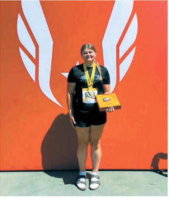Fenja Lawson displays her medal and award after winning the girls 15-16 discus title at the 2026 USATF National Junior Olympic Track &amp; Field Championships in Norwalk, California. Lawson won with a throw of 133 feet, 8 inches. Submitted photo