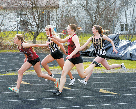 PCN teammates Megan Misson, Jaylynn Stegman, Marlie Stremick and Addelyn Manley racing against the Cardinals team, Meggy Hetletved, Meredith Romfo, Drew Rostvet and McKenna Schneider. The Cardinals would win by a second in the 4X100 relay. Photo by Larry Stokke.