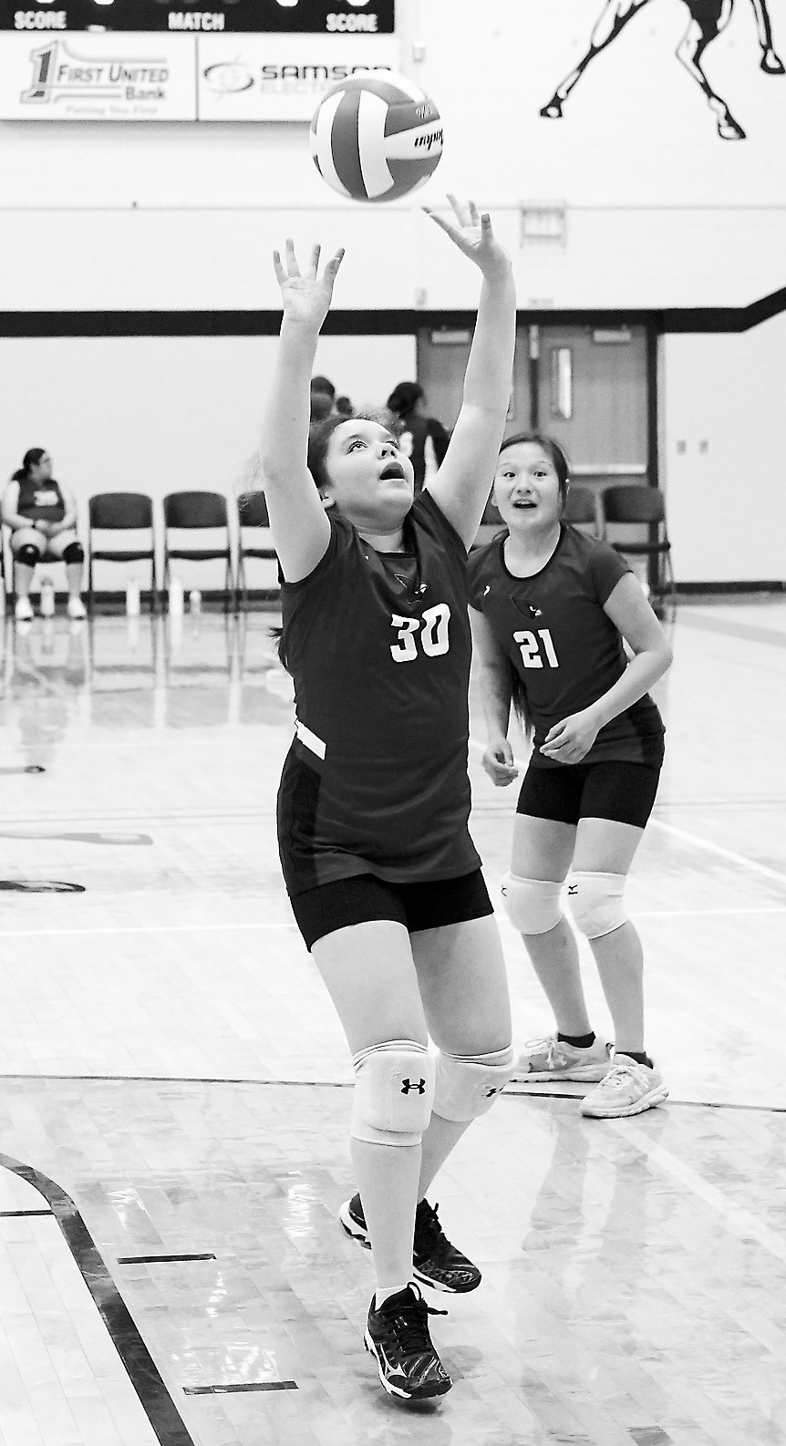 Bridgette Ryan sets the ball high to her teammate. Photo by Larry Stokke.