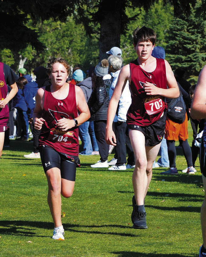Ryder Moser and Logan Mackall pace themselves and run side by side part way around the course. Photo by Larry Stokke.