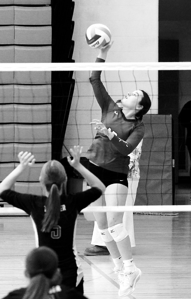 Erika Bakke slams the ball across the net for a point in the Cardinal Invitational Tournament. Photo by Larry Stokke.
