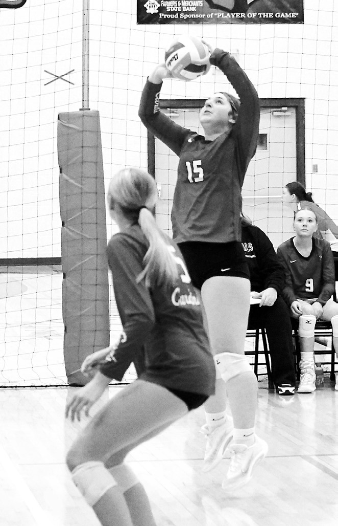 Lexi Gendron sets the ball to a teammate at the Langdon Invitational. Photo by Larry Stokke.