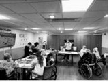 Sixth graders making posters with residents.