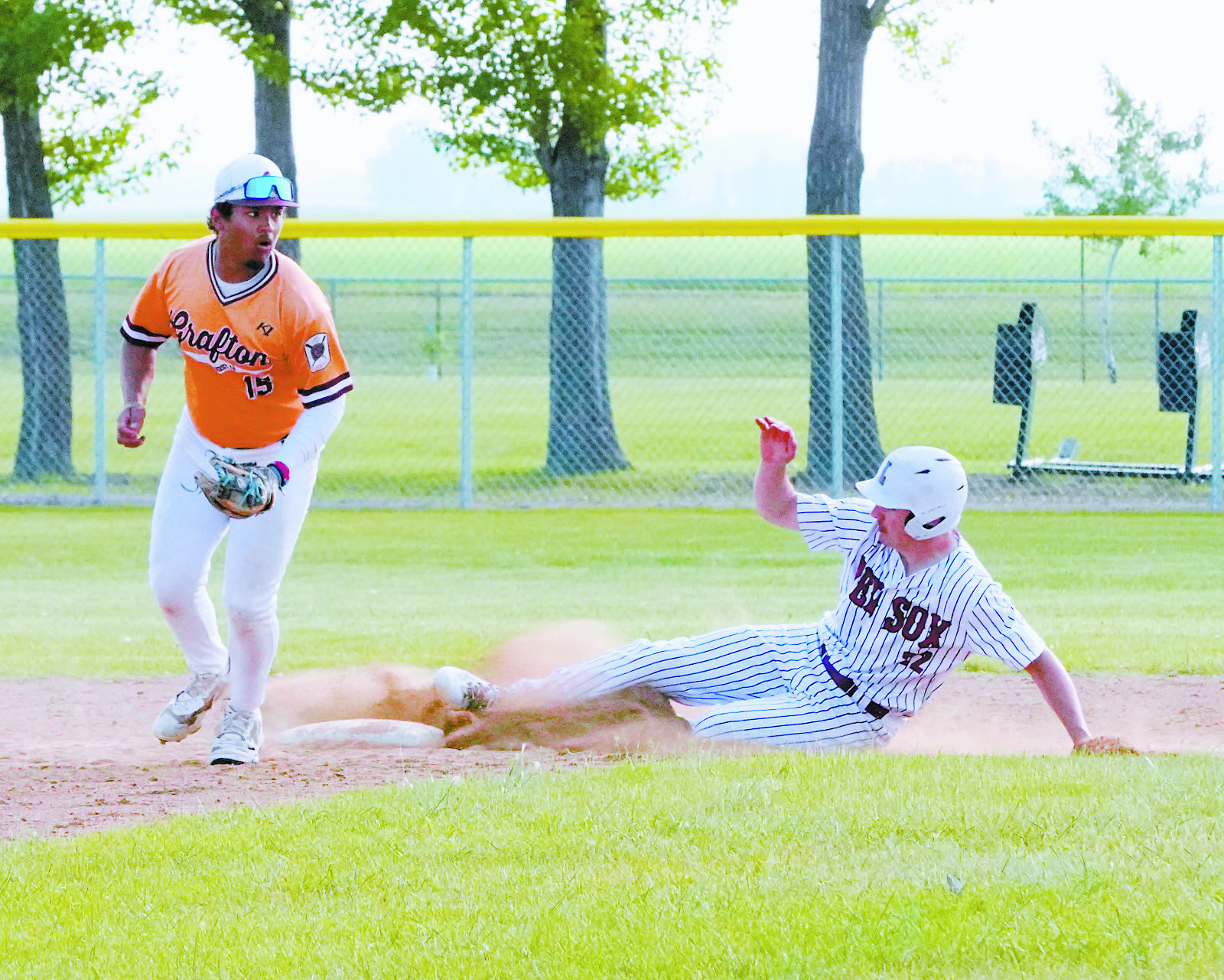 Mason Romfo slides onto second base against Grafton on June 16. Photo by Larry Stokke.