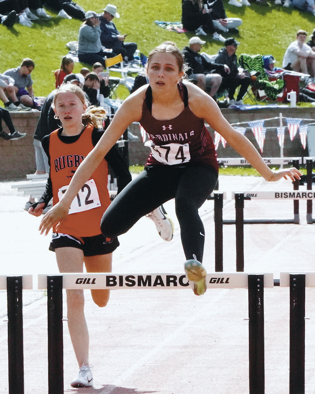 Meggy Hetletved clears the hurdle in the 300 meter race with a time of 50.59. Photo by Larry Stokke.