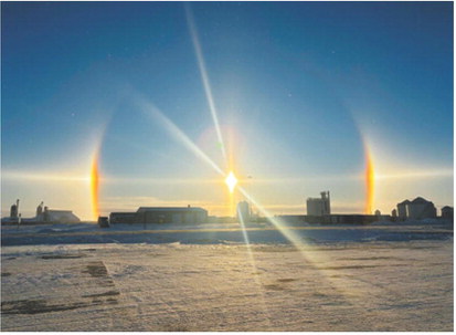 Sun dogs and a solar halo form around the sun as frigid temperatures create ice crystals in the atmosphere over the area. Photo by Rachelle Fetsch