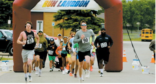 Leading the pack– brothers Kadyn Hein and Dawson Hein lead runners from the starting line during the Run Langdon 5K on June 13 in Langdon. Kadyn finished as the top male runner, with Dawson placing second. Submitted photo