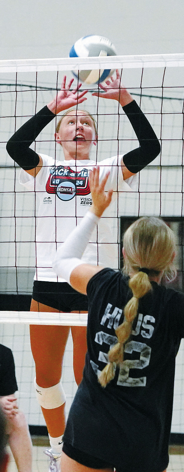 Aubrey Badding eyes the ball and sends it over for a point against Hatton-Northwood. Photo by Larry Stokke.